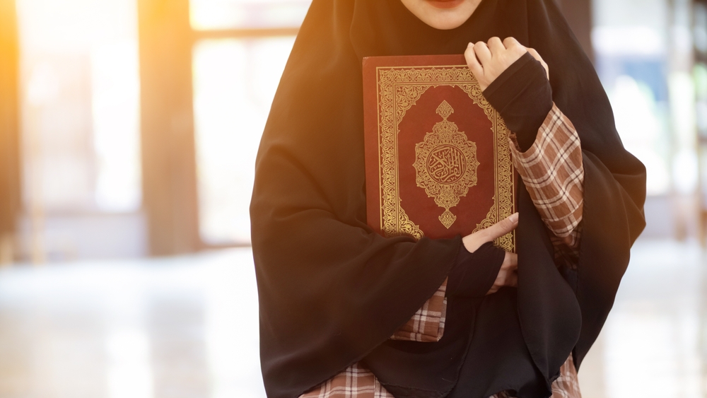 Can a woman recite Quran during menstruation